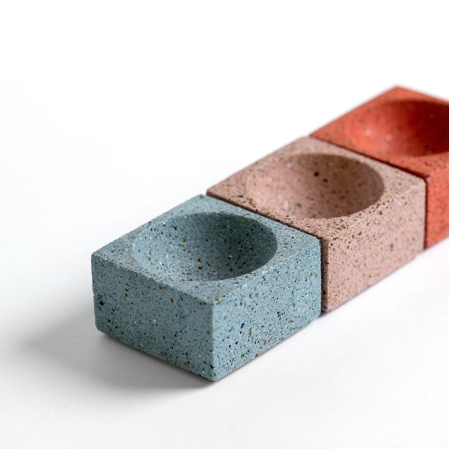 Square concrete terrazzo incense holder in various colors.