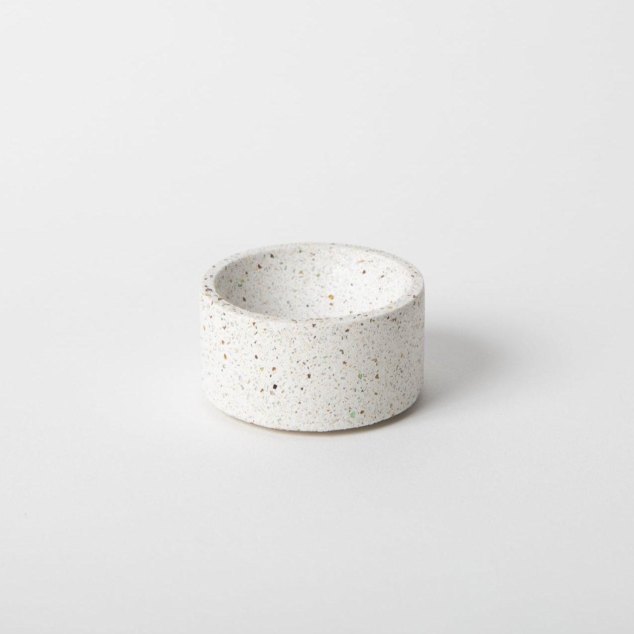 Round terrazzo concrete incense holder in white.
