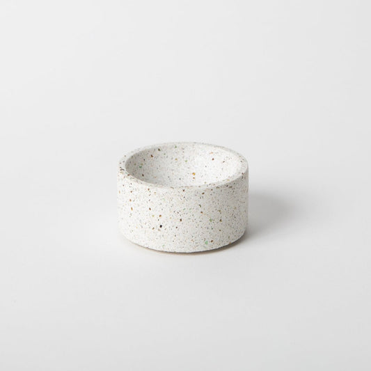 Round terrazzo concrete incense holder in white.