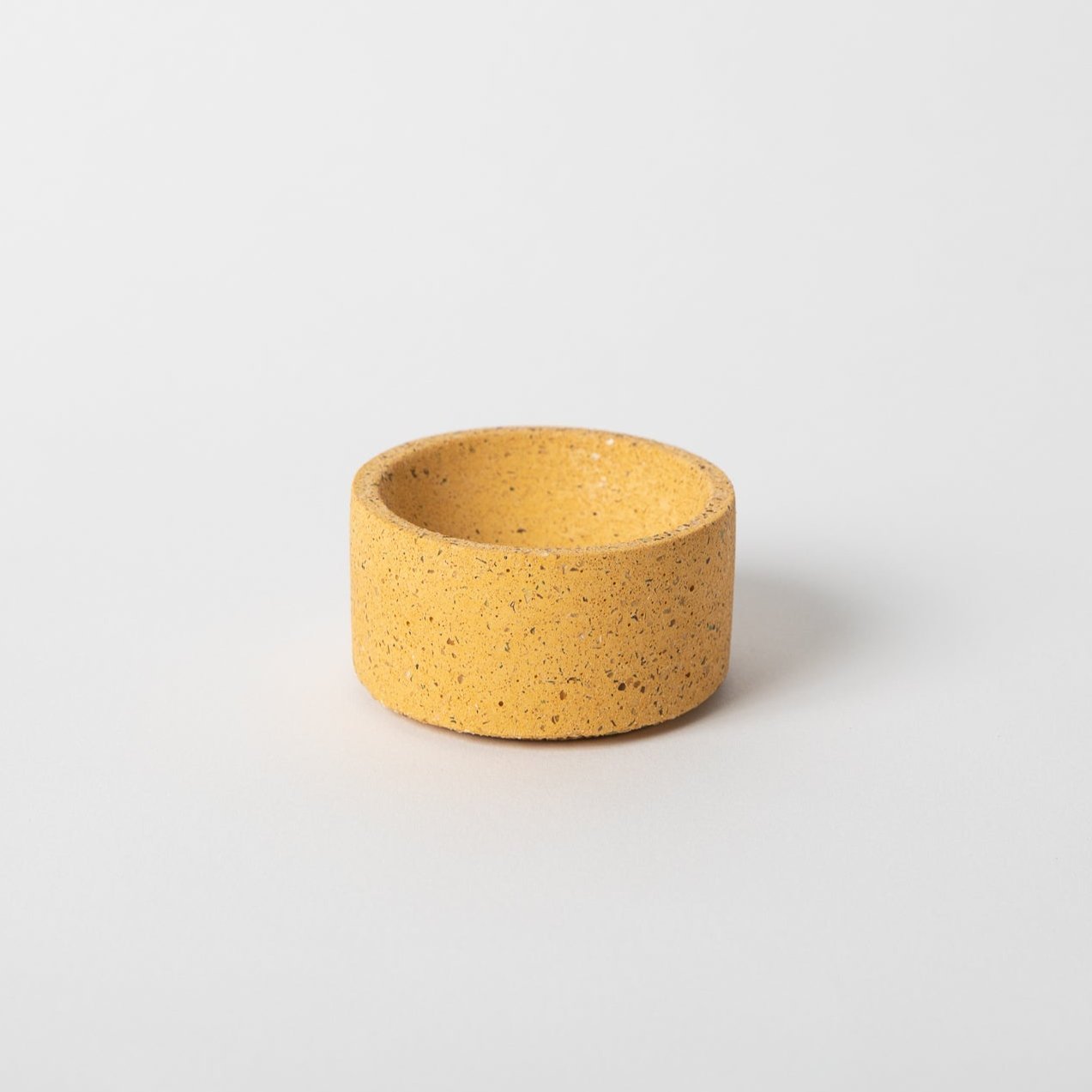 Round terrazzo concrete incense holder in marigold.