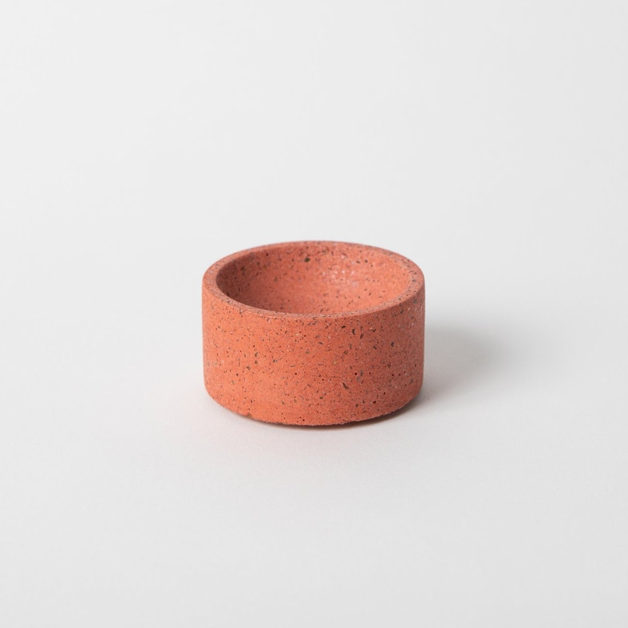 Round terrazzo concrete incense holder in coral.