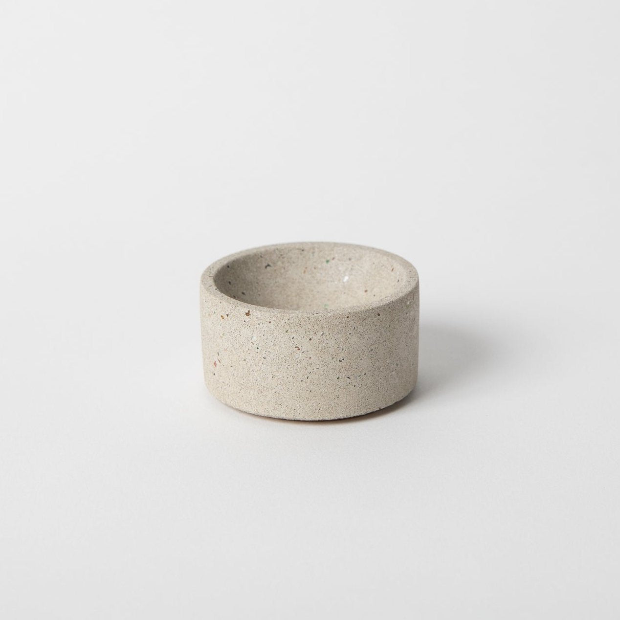 Round terrazzo concrete incense holder in natural.