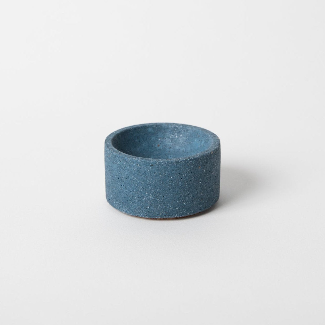 Round terrazzo concrete incense holder in cobalt.