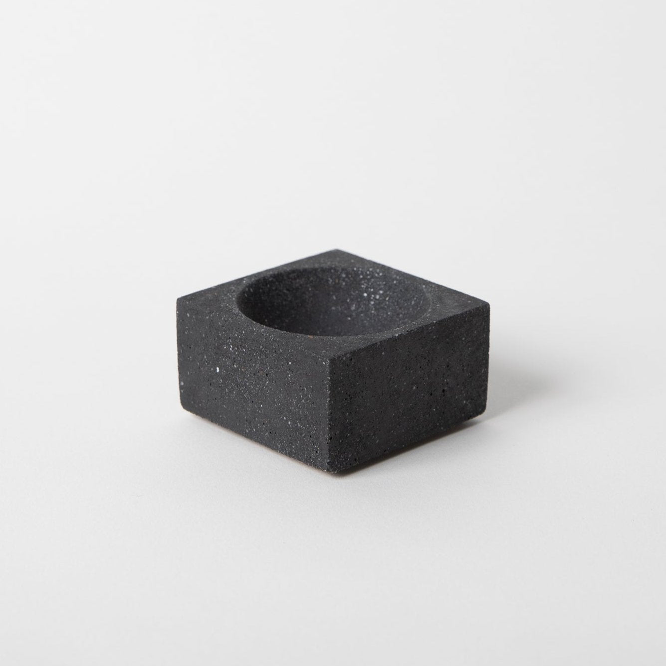 Square concrete terrazzo incense holder in black.
