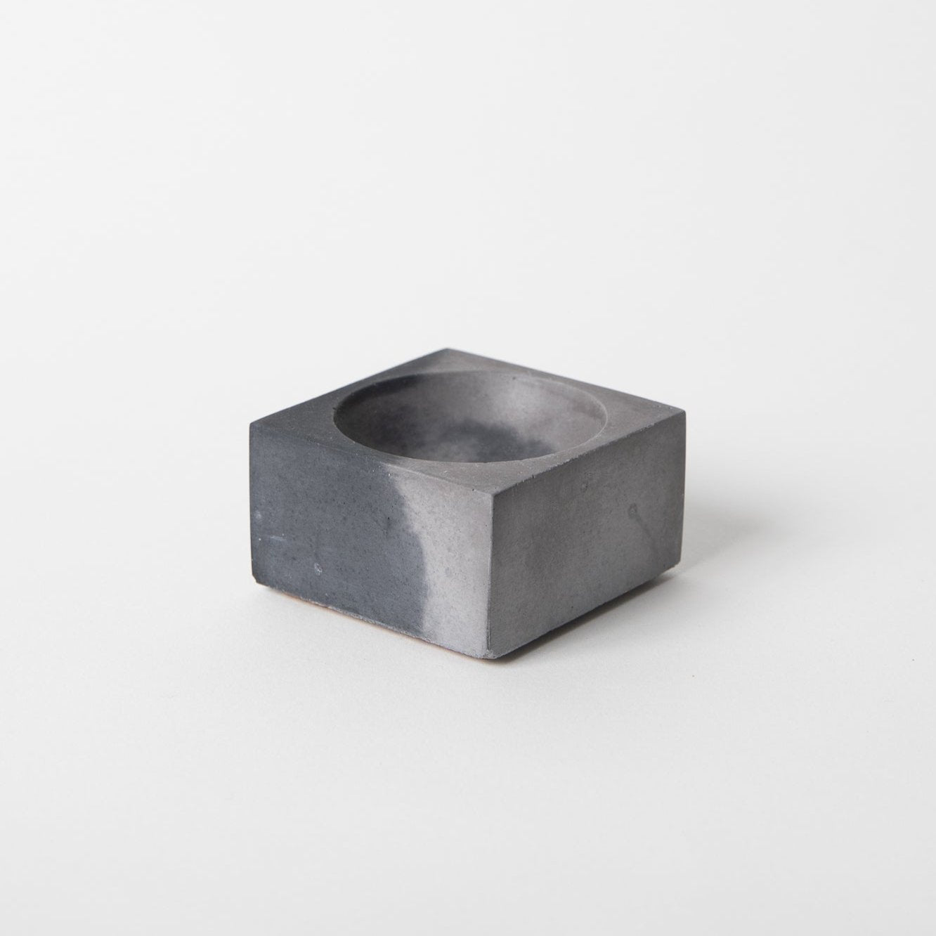 Square concrete incense holder in black and grey.