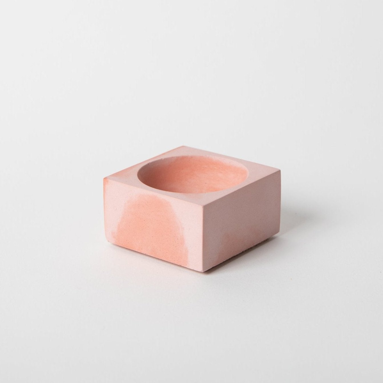 Square concrete incense holder in pink and coral.